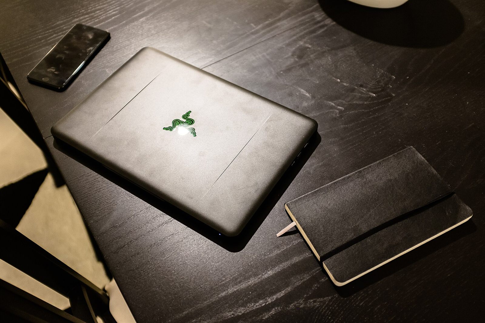 A laptop open on a working desk in the evening